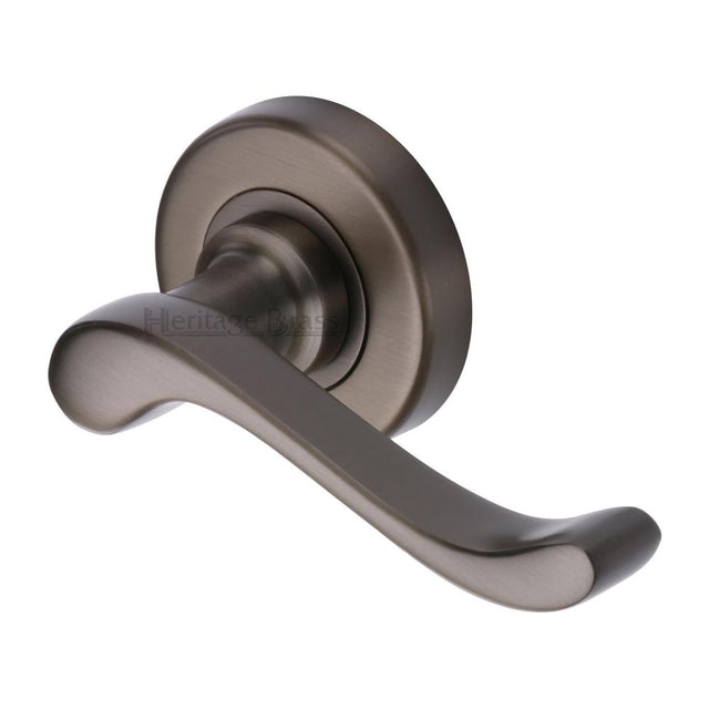 This is an image of a Heritage Brass - Door Handle Lever Latch on 53mm Round Rose Bedford Design Matt, v3010-mb that is available to order from Trade Door Handles in Kendal.