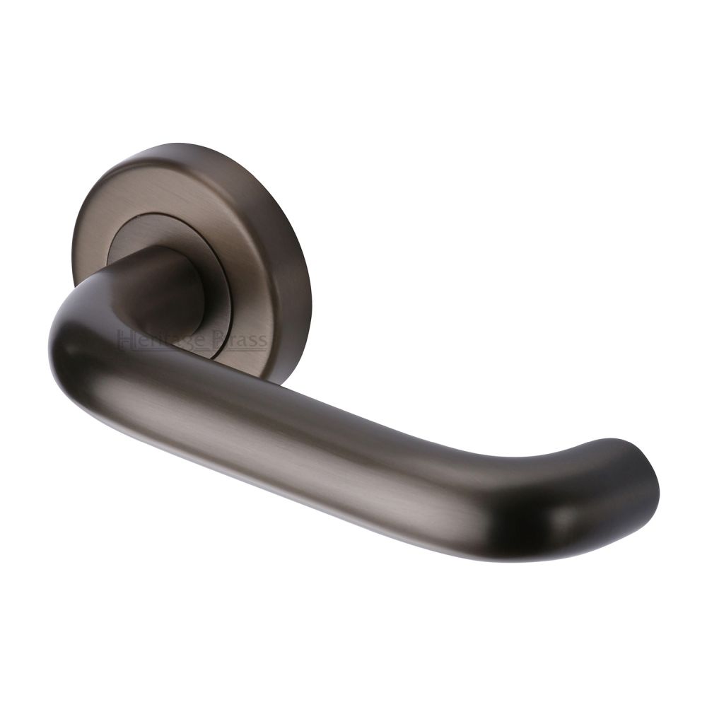 This is an image of a Heritage Brass - Door Handle Lever Latch on Round Rose Harmony Design Matt Bronz, v3090-mb that is available to order from Trade Door Handles in Kendal.