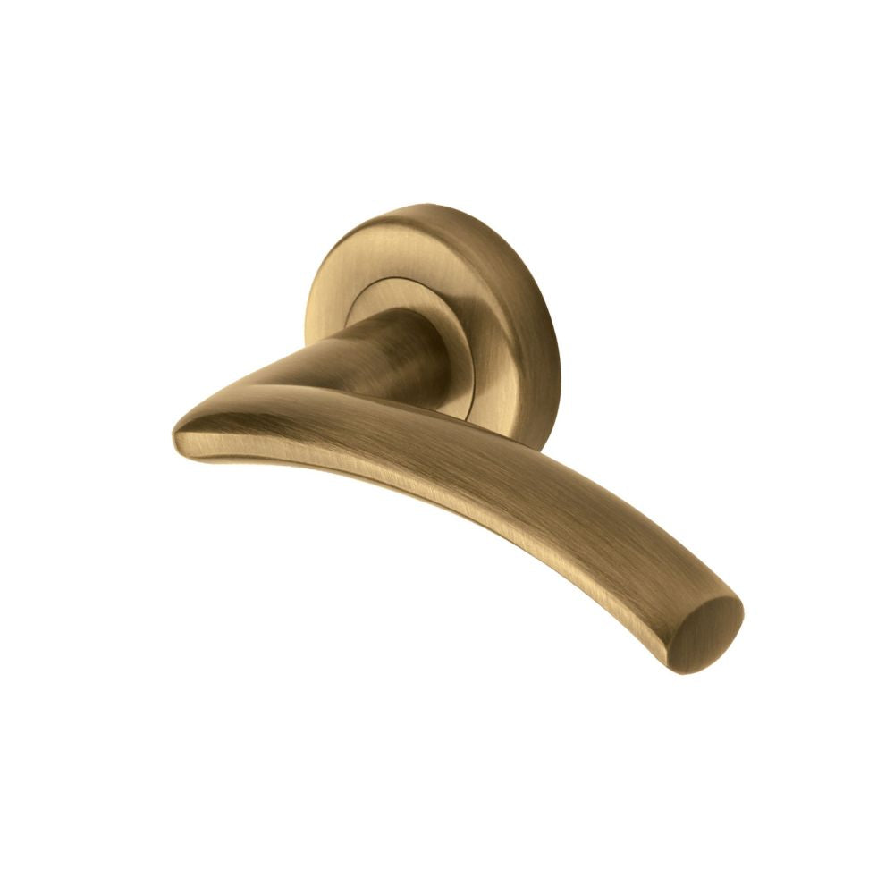 This is an image of a Heritage Brass - Door Handle Lever Latch on Round Rose Centaur Design Antique Brass, v3490-at that is available to order from Trade Door Handles in Kendal.