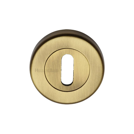 This is an image of a Heritage Brass - Key Escutcheon Antique Brass Finish, v4000-at that is available to order from Trade Door Handles in Kendal.