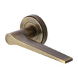 This is an image of a Heritage Brass - Door Handle Lever on Rose Gio Design Antique Brass Finish, v4189-at that is available to order from Trade Door Handles in Kendal.