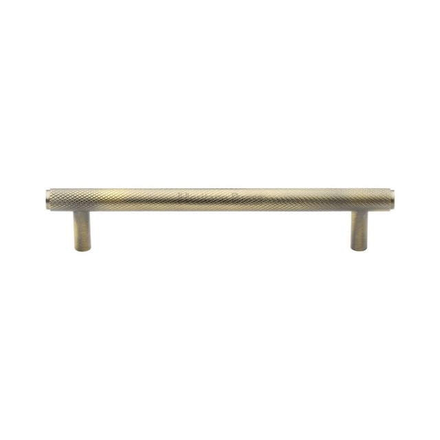 This is an image of a Heritage Brass - Cabinet Pull Knurled Design 128mm CTC Antique Brass Finish, v4458-128-at that is available to order from Trade Door Handles in Kendal.