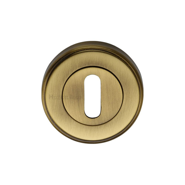 This is an image of a Heritage Brass - Key Escutcheon Antique Brass Finish, v5000-at that is available to order from Trade Door Handles in Kendal.