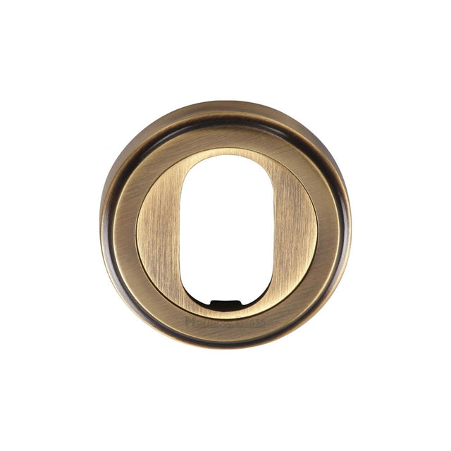 This is an image of a Heritage Brass - Oval Profile Cylinder Escutcheon Antique Brass Finish, v5010-at that is available to order from Trade Door Handles in Kendal.