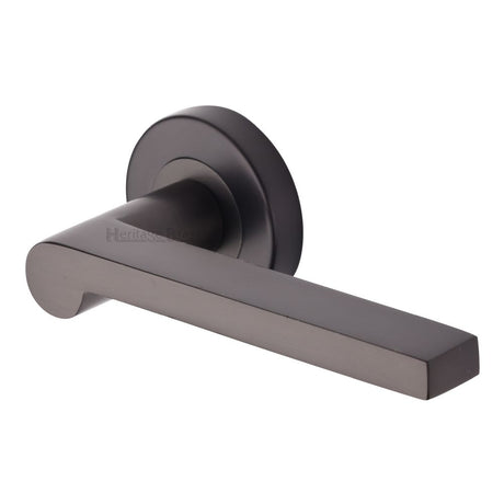 This is an image of a Heritage Brass - Door Handle Lever Latch on Round Rose Metro Mid Century Design, v6225-mb that is available to order from Trade Door Handles in Kendal.