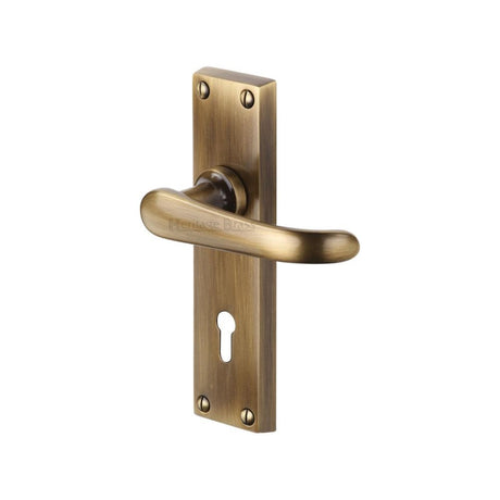 This is an image of a Heritage Brass - Door Handle Lever Lock Windsor Design Antique Brass Finish, v700-at that is available to order from Trade Door Handles in Kendal.