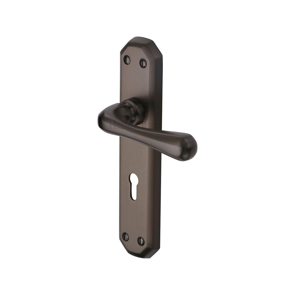 This is an image of a Heritage Brass - Door Handle Lever Lock Charlbury Design Matt Bronze Finish, v7050-mb that is available to order from Trade Door Handles in Kendal.