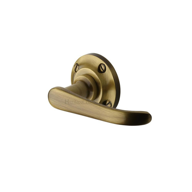 This is an image of a Heritage Brass - Door Handle Lever Latch on Round Rose Windsor Design Antique Brass, v720-at that is available to order from Trade Door Handles in Kendal.