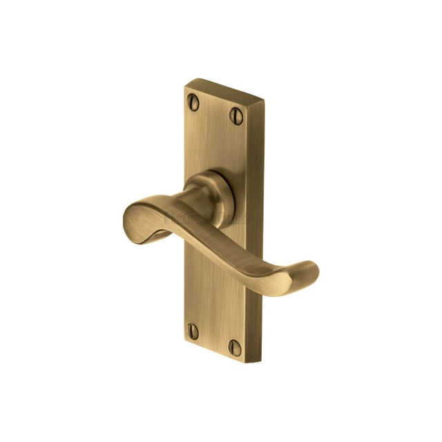 This is an image of a Heritage Brass - Door Handle Lever Latch Bedford Short Design Antique Brass Finish, v800-at that is available to order from Trade Door Handles in Kendal.