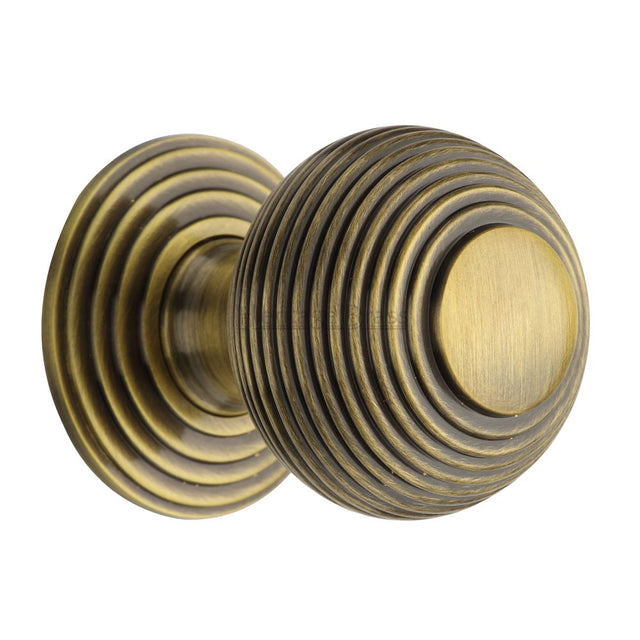 This is a image of a Heritage Brass - Cabinet Knob Reeded Design 38mm Ant. Brass Finish that is available to order from Trade Door Handles in Kendal