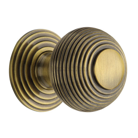 This is an image of a Heritage Brass - Cabinet Knob Reeded Design 38mm Antique Brass Finish, v973-38-at that is available to order from Trade Door Handles in Kendal.