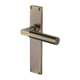 This is an image of a Heritage Brass - Bauhaus Lever Latch Door Handle on 200mm Plate Antique Brass finish, vt6310-at that is available to order from Trade Door Handles in Kendal.