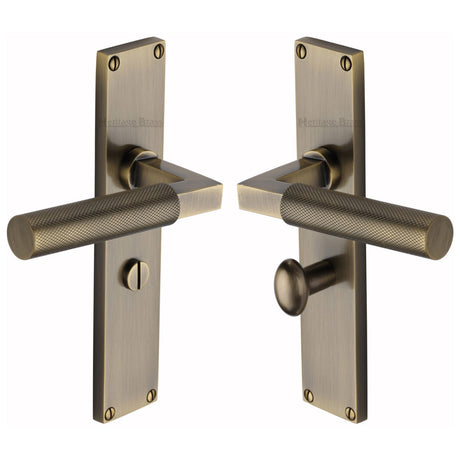 This is an image of a Heritage Brass - Bauhaus Knurled Bathroom Set Door Handle on 200mm Plate Antique Brass finish, vt9330-at that is available to order from Trade Door Handles in Kendal.