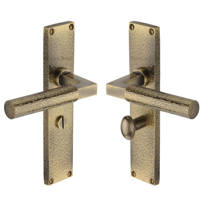 This is an image of a Heritage Brass - Bauhaus Hammered Bathroom Set Door Handle on 200mm Plate Antique Brass finish, vth4330-at that is available to order from Trade Door Handles in Kendal.