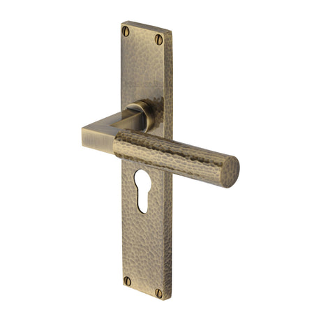 This is an image of a Heritage Brass - Bauhaus Hammered Euro Profile Door Handle on 200mm Plate Antique Brass finish, vth4348-at that is available to order from Trade Door Handles in Kendal.