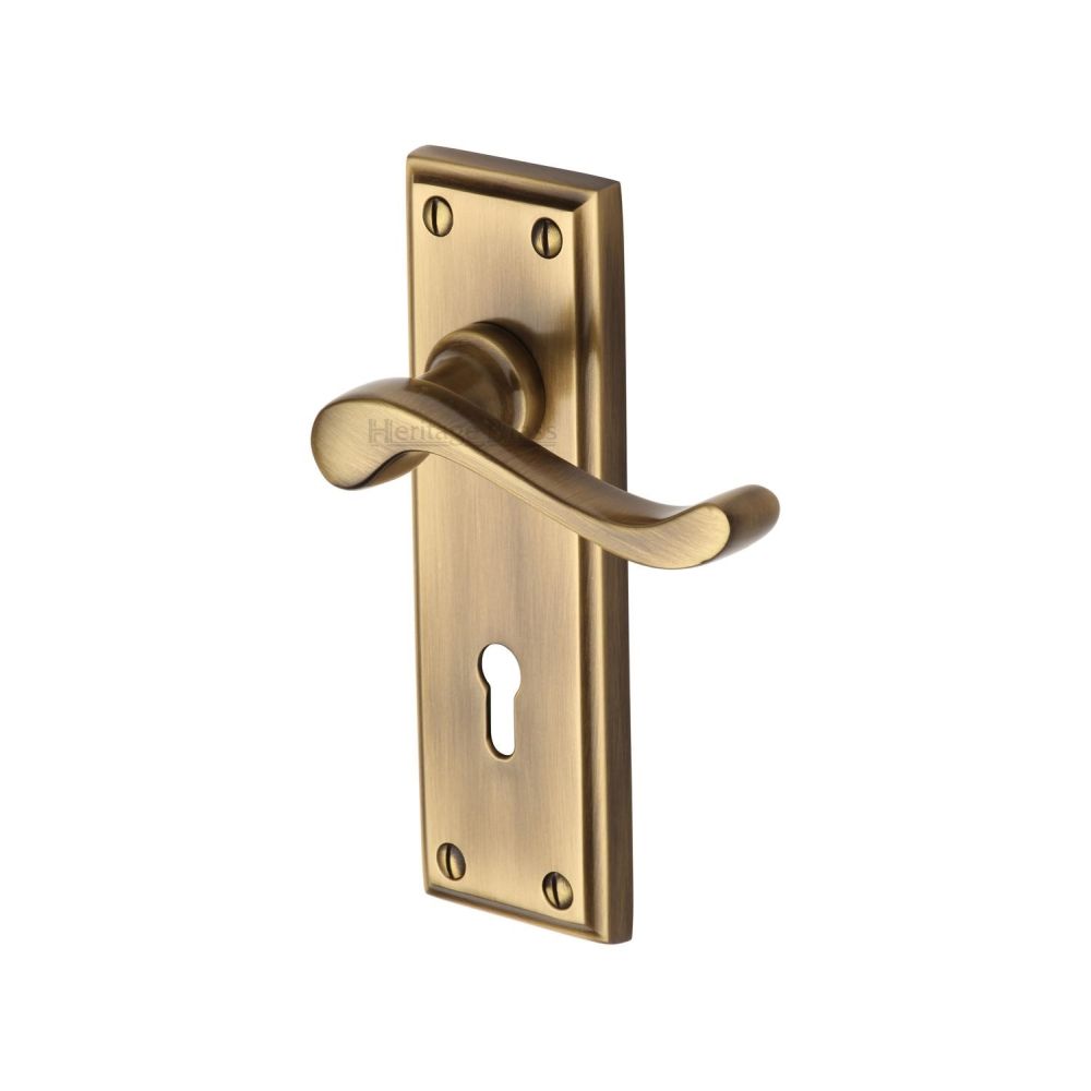 This is an image of a Heritage Brass - Door Handle Lever Lock Edwardian Design Antique Brass Finish, w3200-at that is available to order from Trade Door Handles in Kendal.