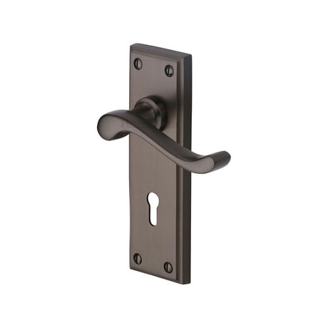 This is an image of a Heritage Brass - Door Handle Lever Lock Edwardian Design Matt Bronze Finish, w3200-mb that is available to order from Trade Door Handles in Kendal.