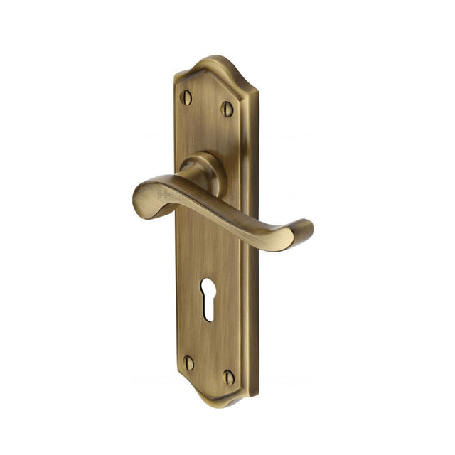 This is an image of a Heritage Brass - Door Handle Lever Lock Buckingham Design Antique Brass Finish, w4200-at that is available to order from Trade Door Handles in Kendal.