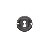 This is an image of a Carlisle Brass - Small Escutcheon - Matt Black that is availble to order from Trade Door Handles in Kendal.