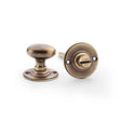 This is an image showing Alexander & Wilks Thumbturn and Release - Antique Brass aw386-ab available to order from Trade Door Handles in Kendal, quick delivery and discounted prices.