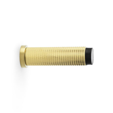 This is an image showing Alexander & Wilks Brunel Knurled Door Stop - Satin Brass PVD aw600-75-sbpvd available to order from Trade Door Handles in Kendal, quick delivery and discounted prices.