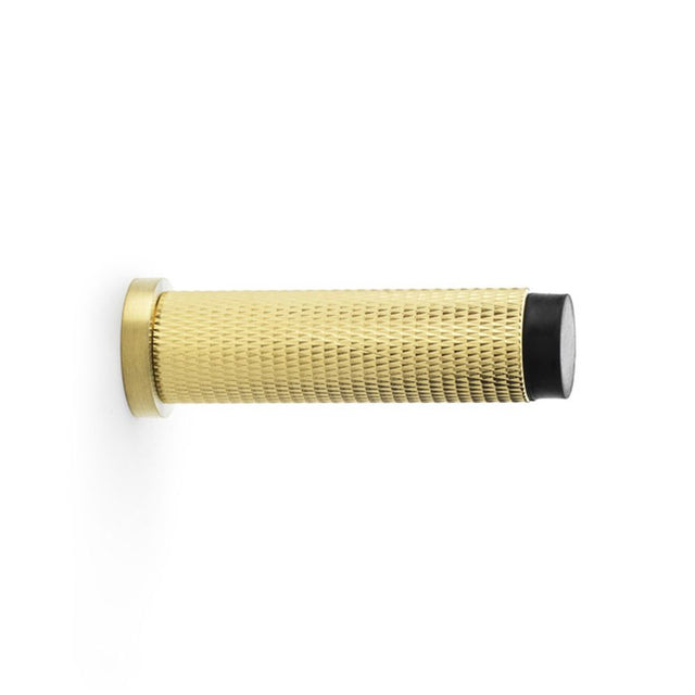 This is an image showing Alexander & Wilks Brunel Knurled Door Stop - Satin Brass PVD aw600-75-sbpvd available to order from Trade Door Handles in Kendal, quick delivery and discounted prices.