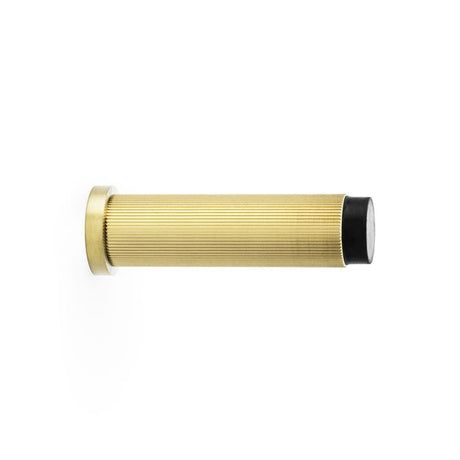 This is an image showing Alexander & Wilks Reeded Projection Door Stop - Satin Brass PVD aw602-75-sbpvd available to order from Trade Door Handles in Kendal, quick delivery and discounted prices.