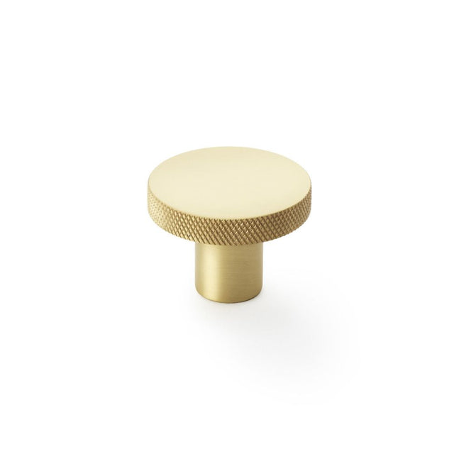 This is an image showing Alexander & Wilks Hanover Knurled Circular Cupboard Knob - Satin Brass - 38mm aw802-38-sb available to order from Trade Door Handles in Kendal, quick delivery and discounted prices.