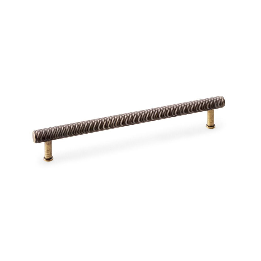 This is an image showing Alexander & Wilks Crispin Knurled T-bar Cupboard Pull Handle - Antique Brass - Centres 224mm aw809-224-ab available to order from Trade Door Handles in Kendal, quick delivery and discounted prices.