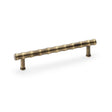 This is an image showing Alexander & Wilks Crispin Bamboo T-bar Cupboard Pull Handle - Antique Brass aw809b-160-ab available to order from Trade Door Handles in Kendal, quick delivery and discounted prices.