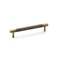 This is an image showing Alexander & Wilks Brunel Knurled T-Bar Cupboard Handle - Antique Brass - Centres 128mm aw810-128-ab available to order from Trade Door Handles in Kendal, quick delivery and discounted prices.