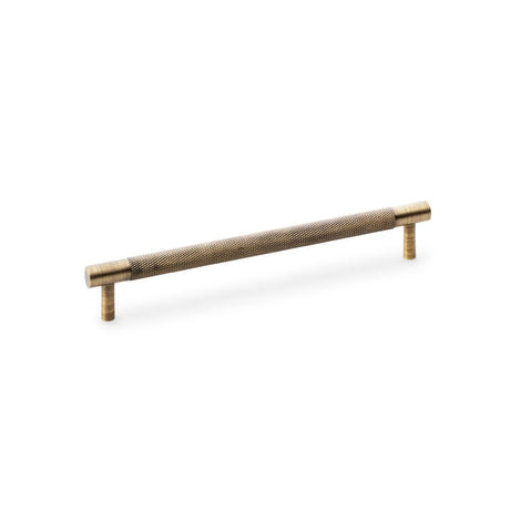 This is an image showing Alexander & Wilks Brunel Knurled T-Bar Cupboard Handle - Antique Brass - Centres 192mm aw810-192-ab available to order from Trade Door Handles in Kendal, quick delivery and discounted prices.