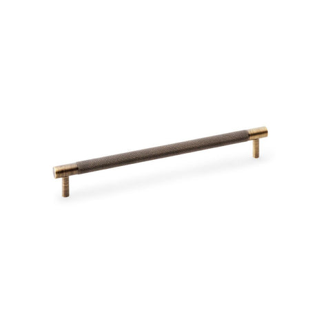 This is an image showing Alexander & Wilks Brunel Knurled T-Bar Cupboard Handle - Antique Brass - Centres 224mm aw810-224-ab available to order from Trade Door Handles in Kendal, quick delivery and discounted prices.