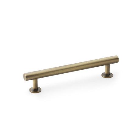 This is an image showing Alexander & Wilks Round T-Bar Cabinet Pull Handle - Antique Brass - Centres 128mm aw814-128-ab available to order from Trade Door Handles in Kendal, quick delivery and discounted prices.