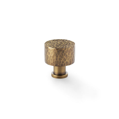 This is an image showing Alexander & Wilks Leila - Hammered Cupboard Knob - Antique Brass - 30mm aw816-30-ab available to order from Trade Door Handles in Kendal, quick delivery and discounted prices.