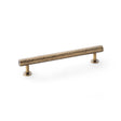 This is an image showing Alexander & Wilks Leila Hammered Cabinet Pull - Antique Brass aw817-160-ab available to order from Trade Door Handles in Kendal, quick delivery and discounted prices.