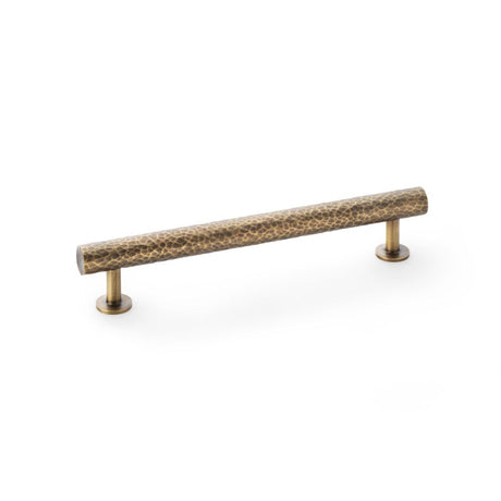 This is an image showing Alexander & Wilks Leila Hammered Cabinet Pull - Antique Brass aw817-160-ab available to order from Trade Door Handles in Kendal, quick delivery and discounted prices.