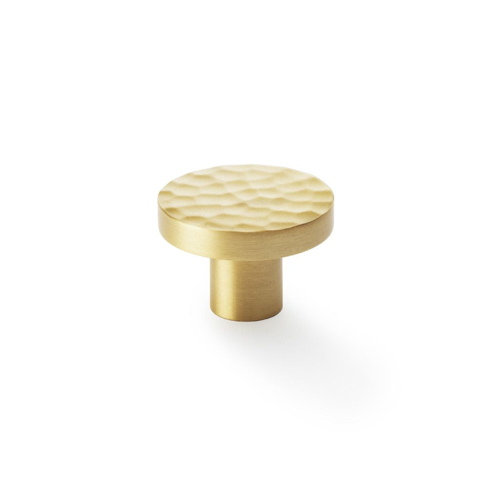 This is an image showing Alexander & Wilks Hanover Hammered Cupboard Knob - Satin Brass - 38mm aw820-38-sb available to order from Trade Door Handles in Kendal, quick delivery and discounted prices.