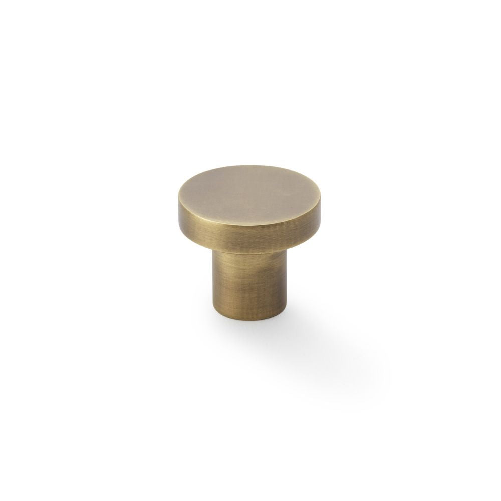 This is an image showing Alexander & Wilks Hanover Plain Cupboard Knob - Antique Brass - Knob 30mm aw821-30-ab available to order from Trade Door Handles in Kendal, quick delivery and discounted prices.