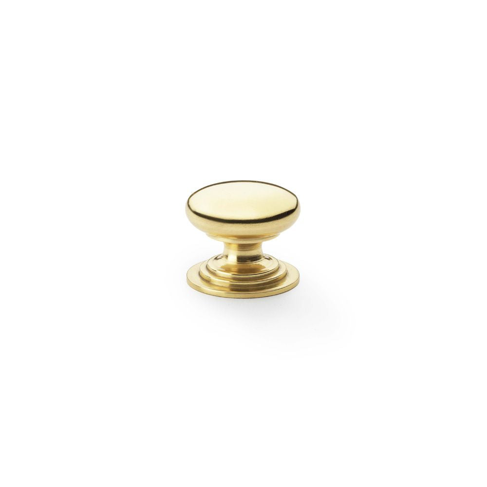 This is an image showing Alexander & Wilks Waltz Round Cupboard Knob on Stepped Rose - Polished Brass - 25mm aw825-25-pbl available to order from Trade Door Handles in Kendal, quick delivery and discounted prices.