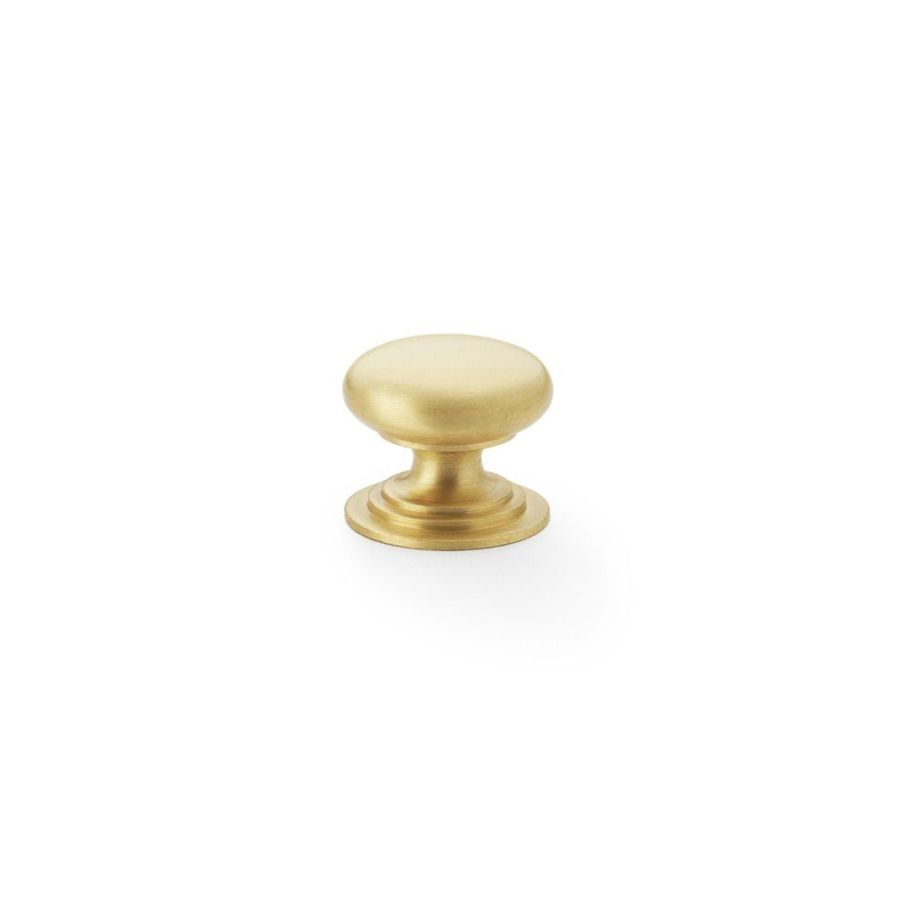 This is an image showing Alexander & Wilks Waltz Round Cupboard Knob on Stepped Rose - Satin Brass - 25mm aw825-25-sb available to order from Trade Door Handles in Kendal, quick delivery and discounted prices.