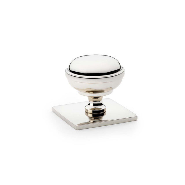 This is an image showing Alexander & Wilks Quantock Cupboard Knob on Square Backplate - Polished Nickel - 34mm aw826-34-pn available to order from Trade Door Handles in Kendal, quick delivery and discounted prices.