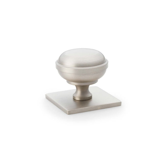 This is an image showing Alexander & Wilks Quantock Cupboard Knob on Square Backplate - Satin Nickel - 34mm aw826-34-sn available to order from Trade Door Handles in Kendal, quick delivery and discounted prices.