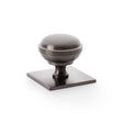 This is an image showing Alexander & Wilks Quantock Cupboard Knob on Square Backplate - Dark Bronze PVD - 38mm aw826-38-dbzpvd available to order from Trade Door Handles in Kendal, quick delivery and discounted prices.