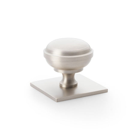 This is an image showing Alexander & Wilks Quantock Cupboard Knob on Square Backplate - Satin Nickel - 38mm aw826-38-sn available to order from Trade Door Handles in Kendal, quick delivery and discounted prices.