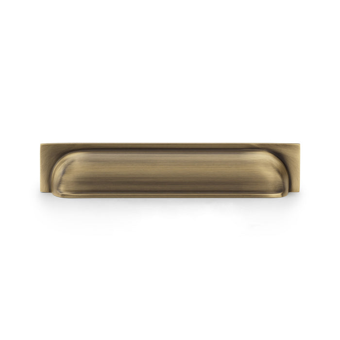 This is an image showing Alexander & Wilks Quantock Cup Pull Handle - Antique Brass - Centres 203mm aw906ab available to order from Trade Door Handles in Kendal, quick delivery and discounted prices.