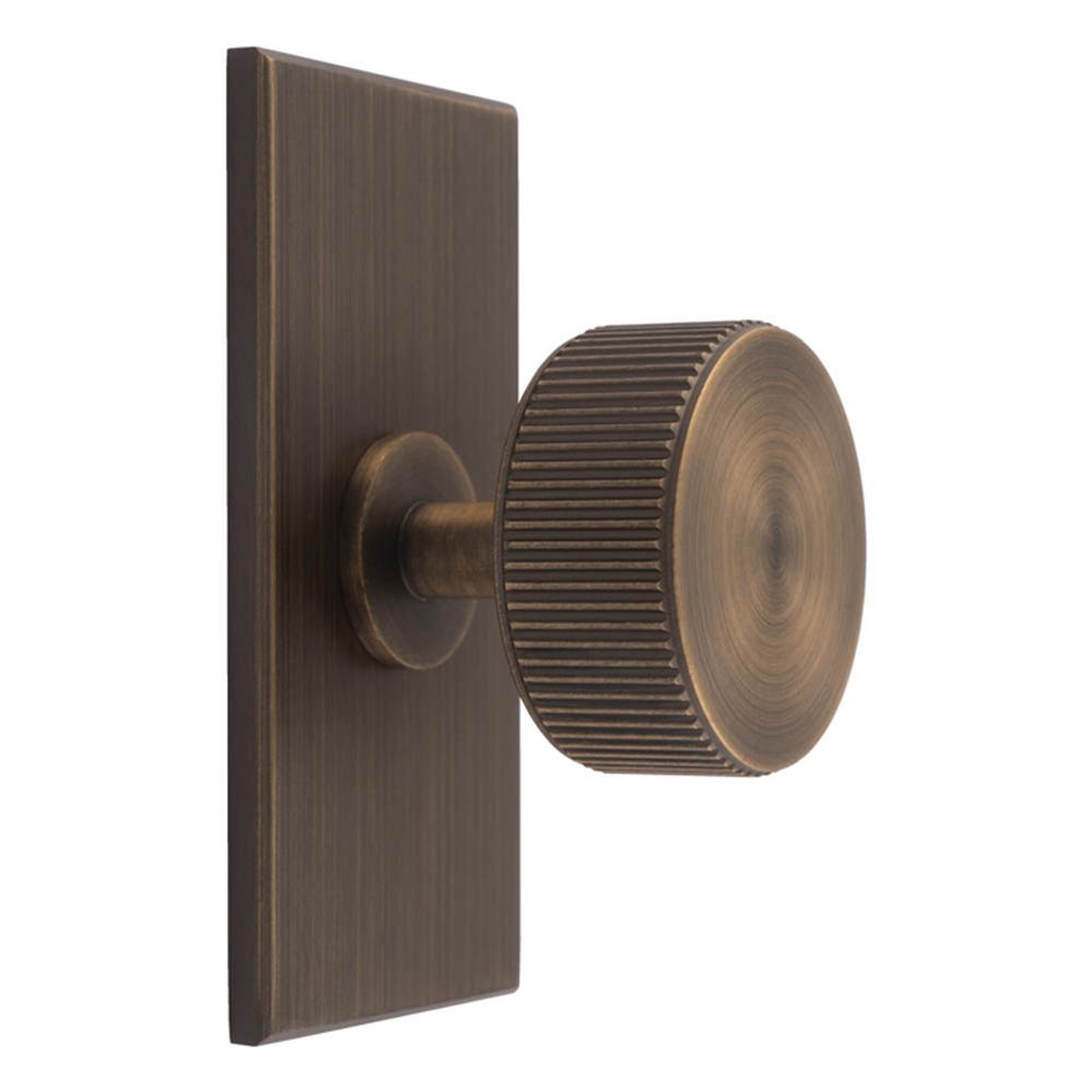 This is an image of a Carlisle Brass - Lines Radio Knob on Backplate that is availble to order from Trade Door Handles in Kendal.