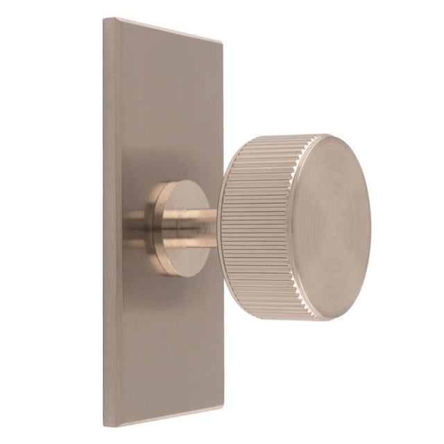 This is an image of a Carlisle Brass - Lines Radio Knob on Backplate that is availble to order from Trade Door Handles in Kendal.