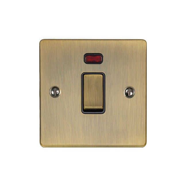 This is an image showing Eurolite Enhance Decorative 20Amp Switch with Neon Indicator - Antique Brass (With Black Trim) en20aswnabb available to order from trade door handles, quick delivery and discounted prices.