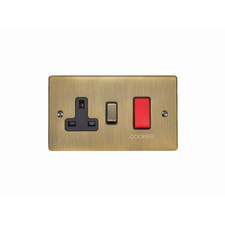 This is an image showing Eurolite Enhance Decorative 45Amp Switch with a socket - Antique Brass (With Black Trim) en45aswasabb available to order from trade door handles, quick delivery and discounted prices.